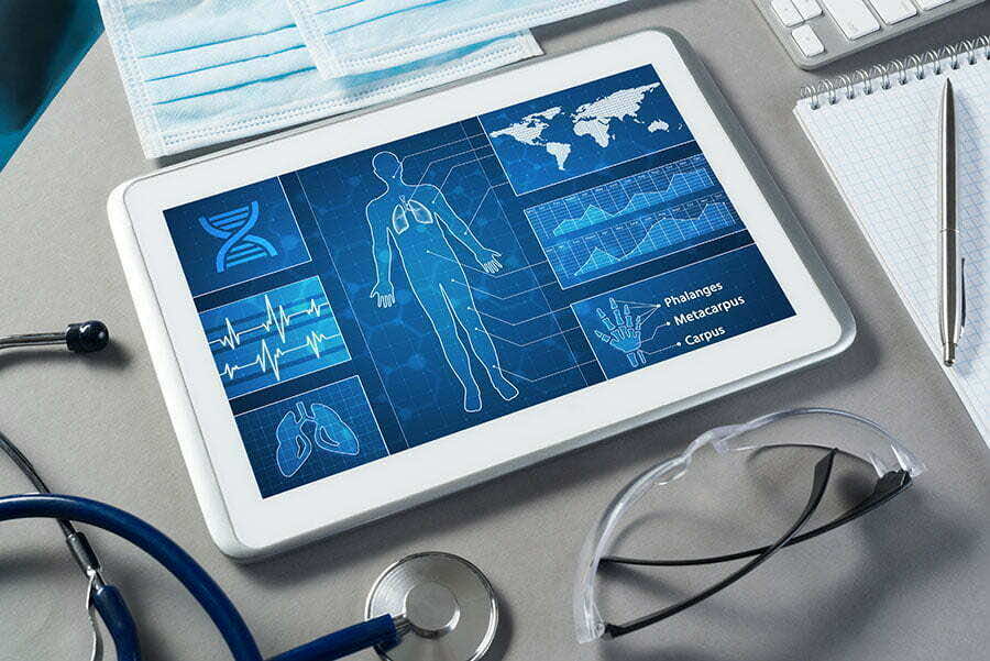 White tablet pc and doctor tools on gray surface